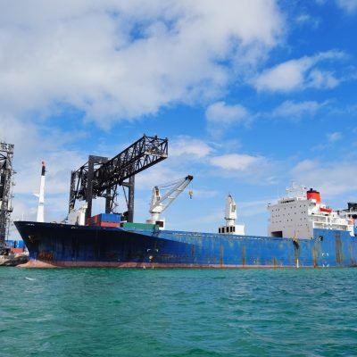 cargo-ship-miami-harbor-with-crane-blue-sky-sea-scaled.jpg